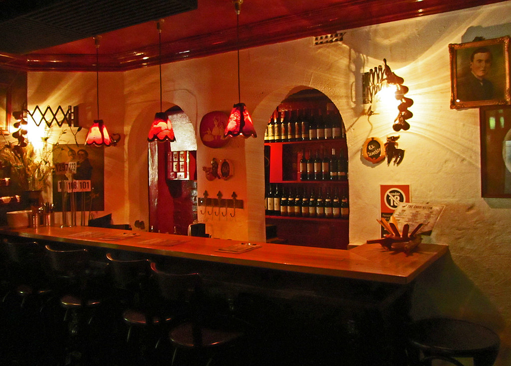 A warm, intimate bar lined with bottles for a relaxed first-date drink in Phuket